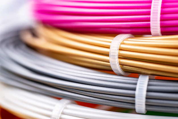 bunch-of-colorful-rolled-cables-closeup-of-plastic-bright-wires-for-3d-printer-lying-indoors-white-studio-background-concept-of-children-s-entertainment-and-creativity_212944-14497